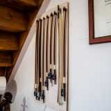Ci guardiamo intorno. Appesi ai muri notiamo una fila di archi necessari per suonare lo strumento: sono costituiti da una bacchetta curvata di legno brasiliano (il pernambuco) e da un fascio di crini di cavallo bianco